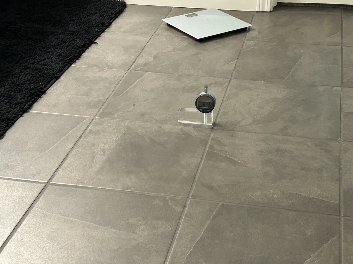 Flooring Specialists 1 Flooring Specialists tile-floor inspection with a gauge positioned across a tile joint