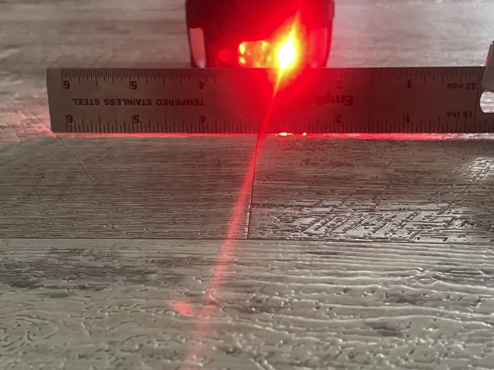 Rigid-core plank surface checked during a flooring inspection