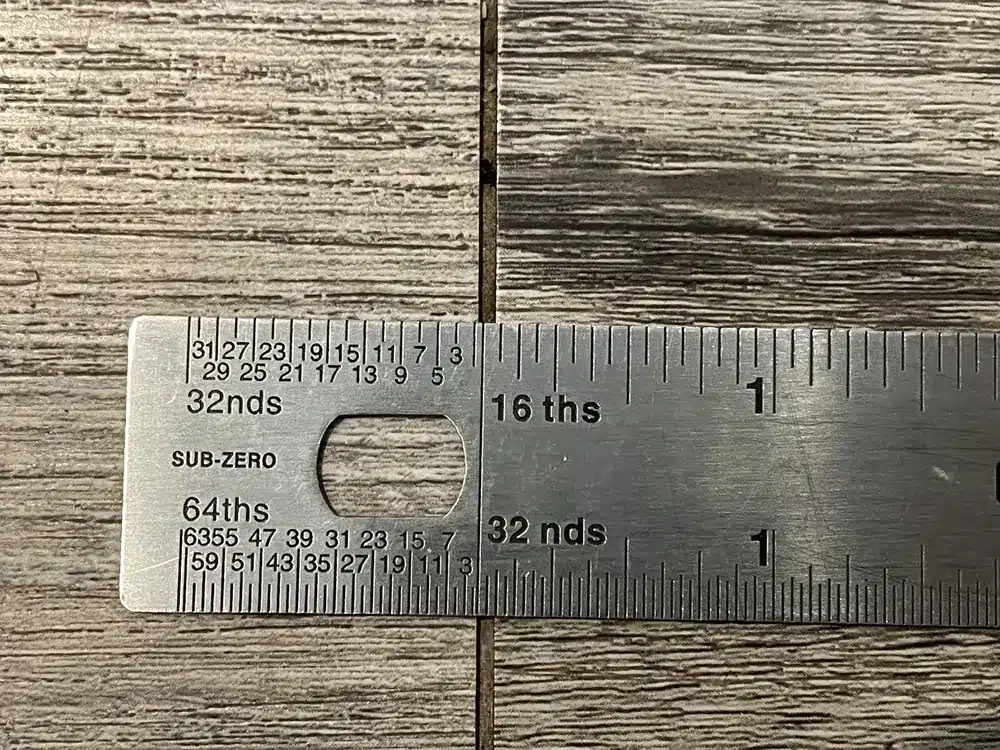 Open end joint in rigid-core vinyl flooring documented during an inspection